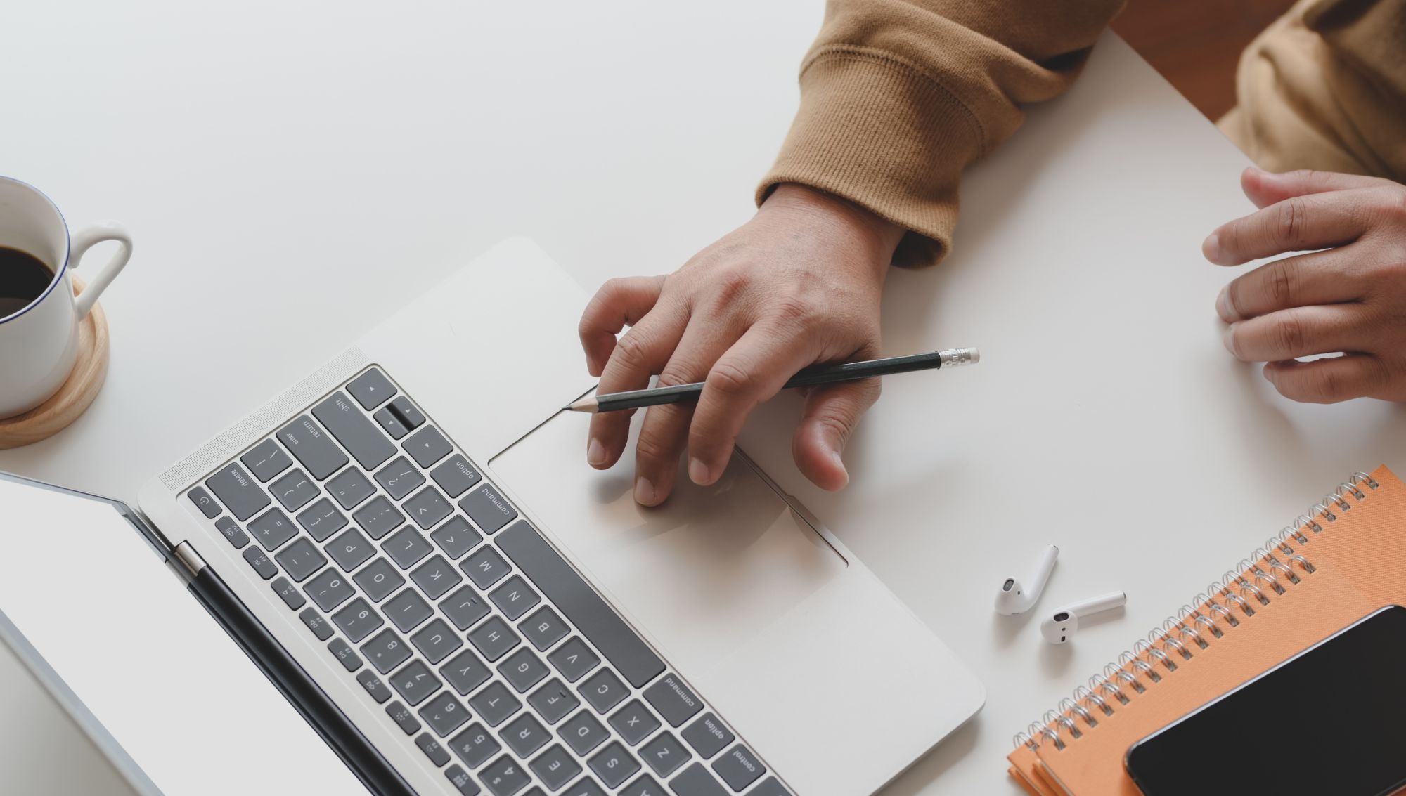 Mortgage Broker in Tucson, AZ,, working at their computer, reviewing mortgage applications and assisting clients with home financing.